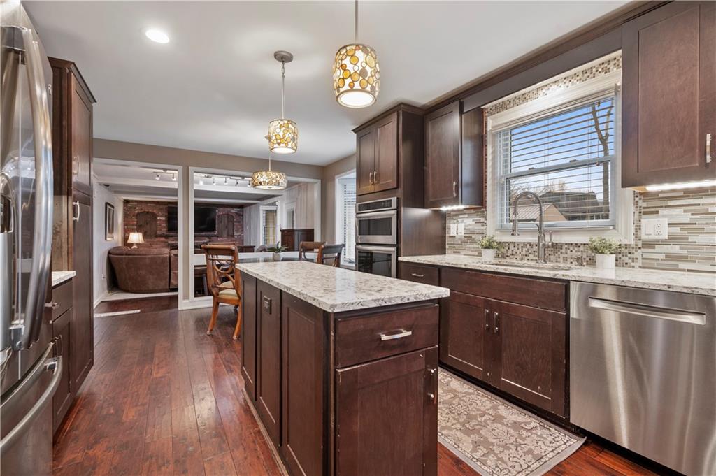 1787 Hassam Road Coraopolis, PA 15108 - Photo 6 of 28 The kitchen has stainless appliances including a 36" Wolf 5-burner gas stove and hardwood floors. Custom lighting adds the perfect touch.
