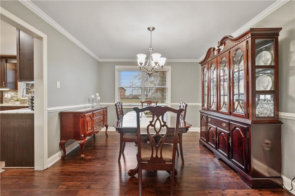 1787 Hassam Road Coraopolis, PA 15108 - Photo 10 of 28 The formal dining room offers hardwood floors and is accented with crown molding and a chair rail.