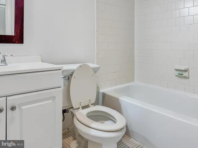 a bathroom with a sink a toilet and bathtub