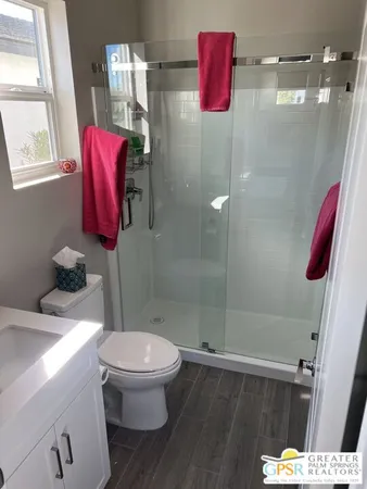 a white toilet sitting next to a bathroom sink