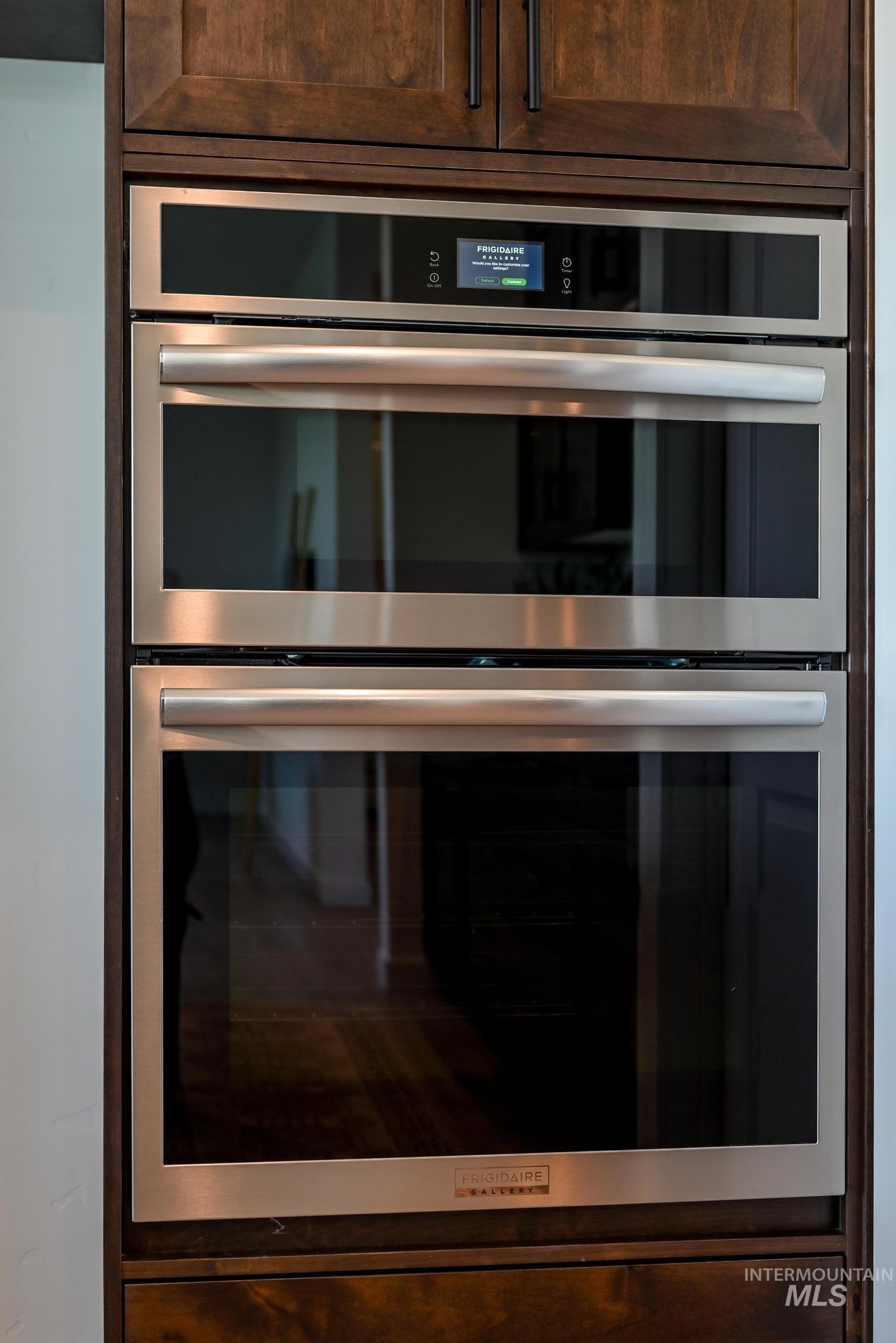 15086 Steel Cloud Avenue Caldwell, ID 83607 - Photo 14 of 41 Kitchen view of double oven and dark brown cabinetry