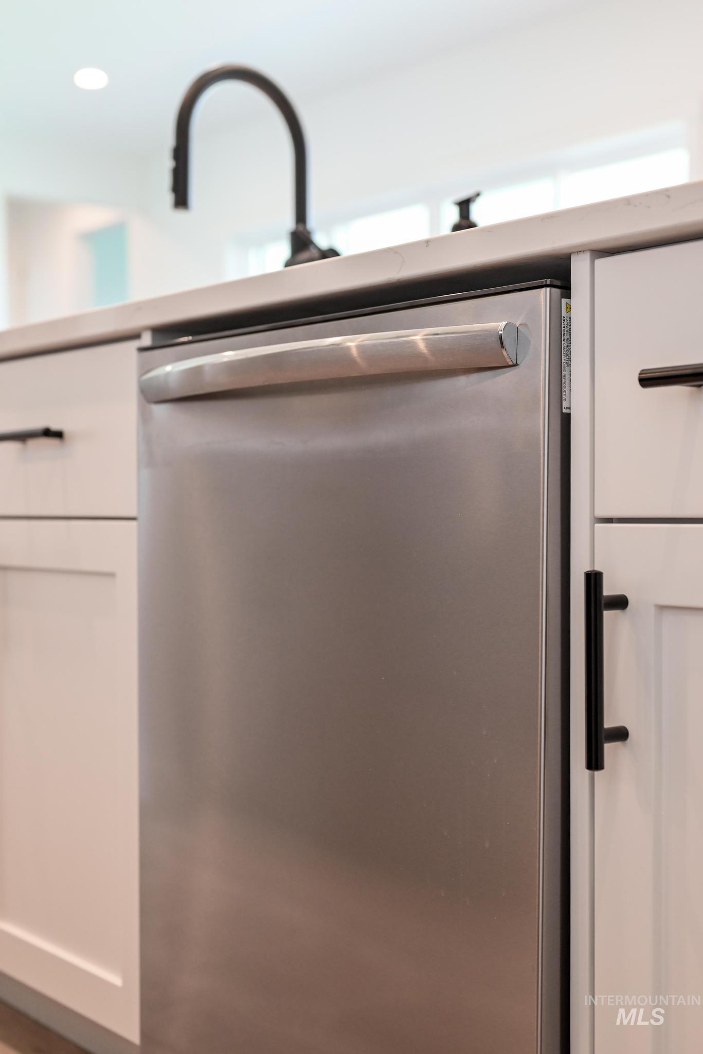 15086 Steel Cloud Avenue Caldwell, ID 83607 - Photo 15 of 41 Kitchen view of stainless steel dishwasher, white cabinets, and recessed lighting