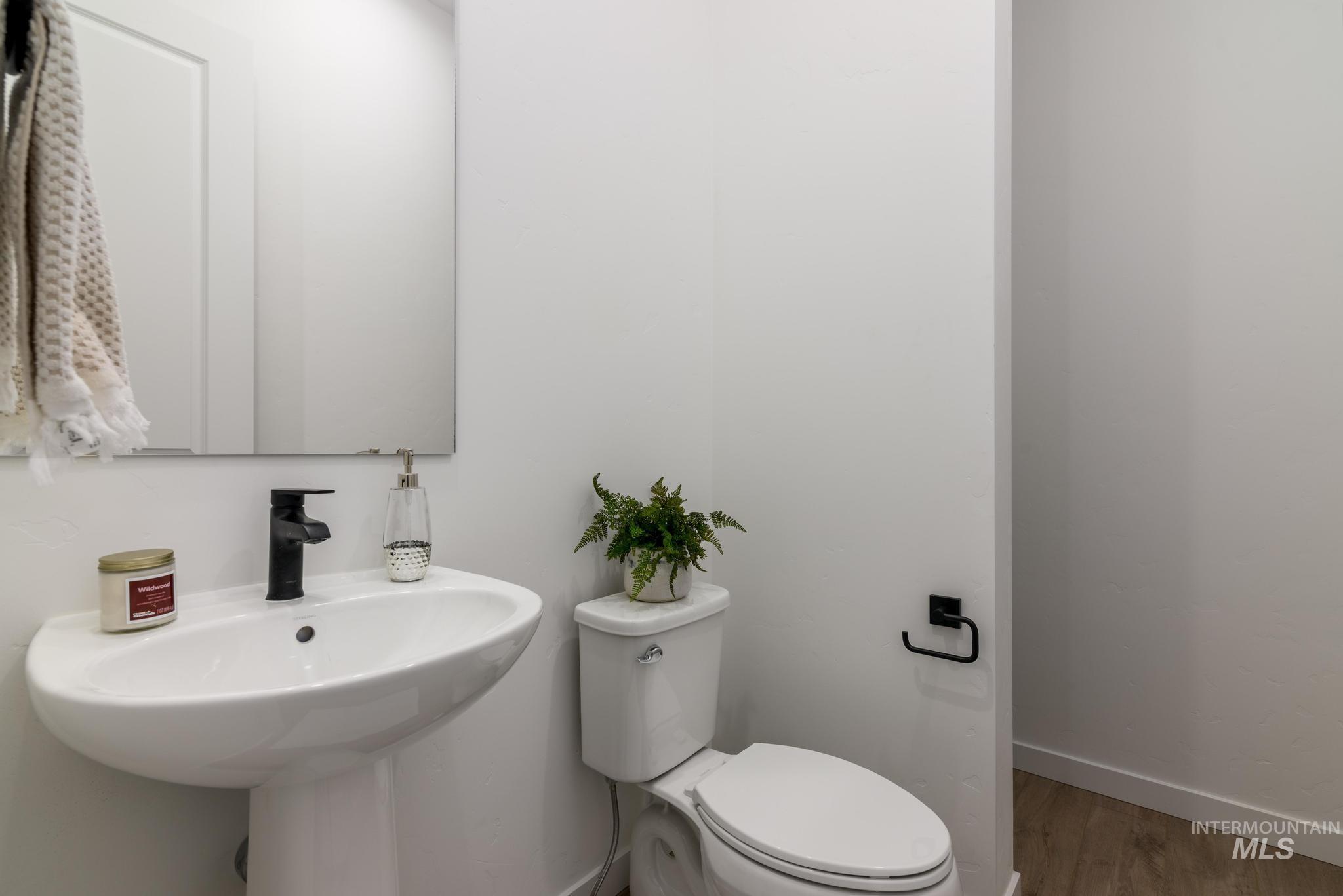 15086 Steel Cloud Avenue Caldwell, ID 83607 - Photo 19 of 41 Half bath with toilet and wood finished floors