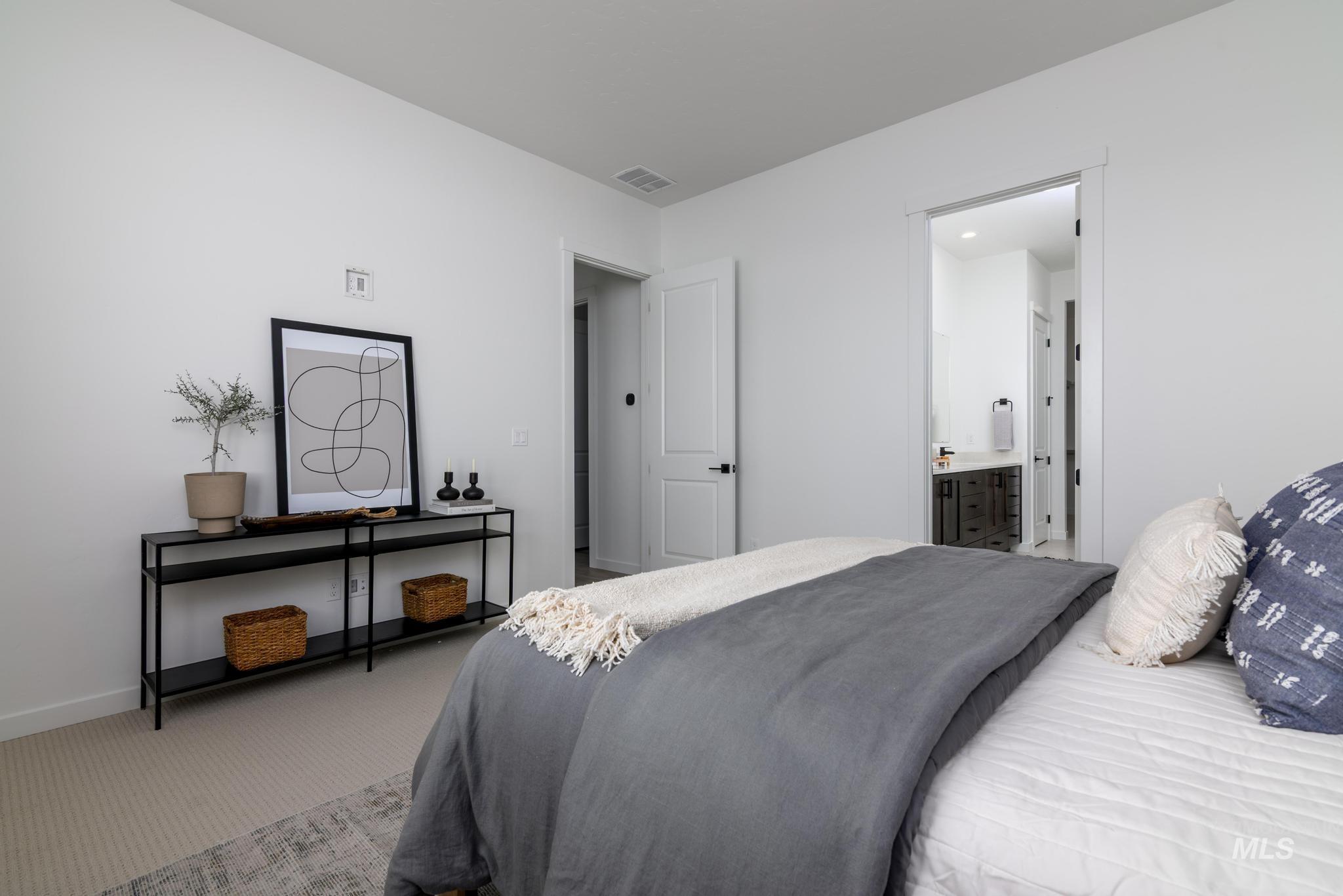 15086 Steel Cloud Avenue Caldwell, ID 83607 - Photo 20 of 41 Carpeted bedroom featuring baseboards and ensuite bath
