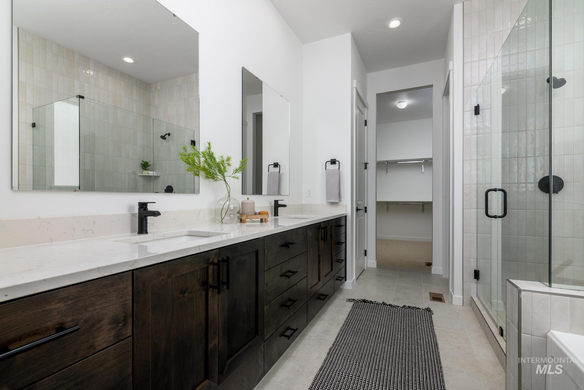 15086 Steel Cloud Avenue Caldwell, ID 83607 - Photo 22 of 41 Bathroom featuring a stall shower, double vanity, tile patterned floors, a walk in closet, and recessed lighting