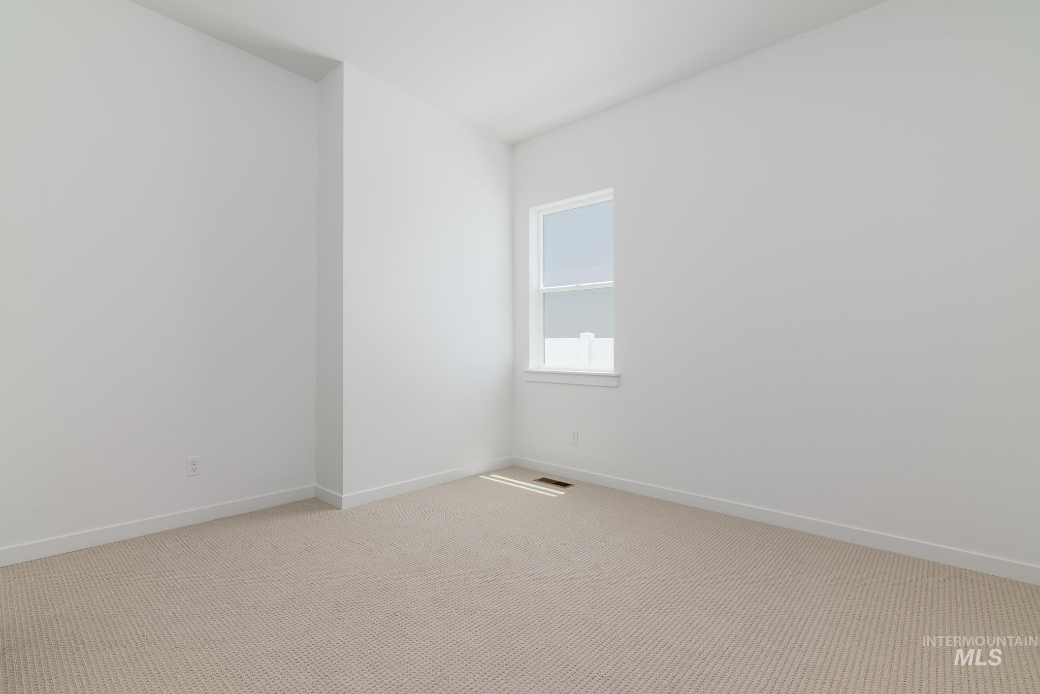 15086 Steel Cloud Avenue Caldwell, ID 83607 - Photo 25 of 41 Unfurnished room with light colored carpet and baseboards
