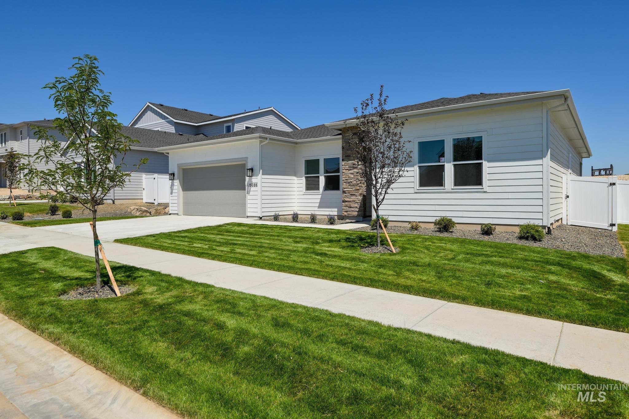 15086 Steel Cloud Avenue Caldwell, ID 83607 - Photo 3 of 41 View of front facade featuring driveway, a garage, and a gate