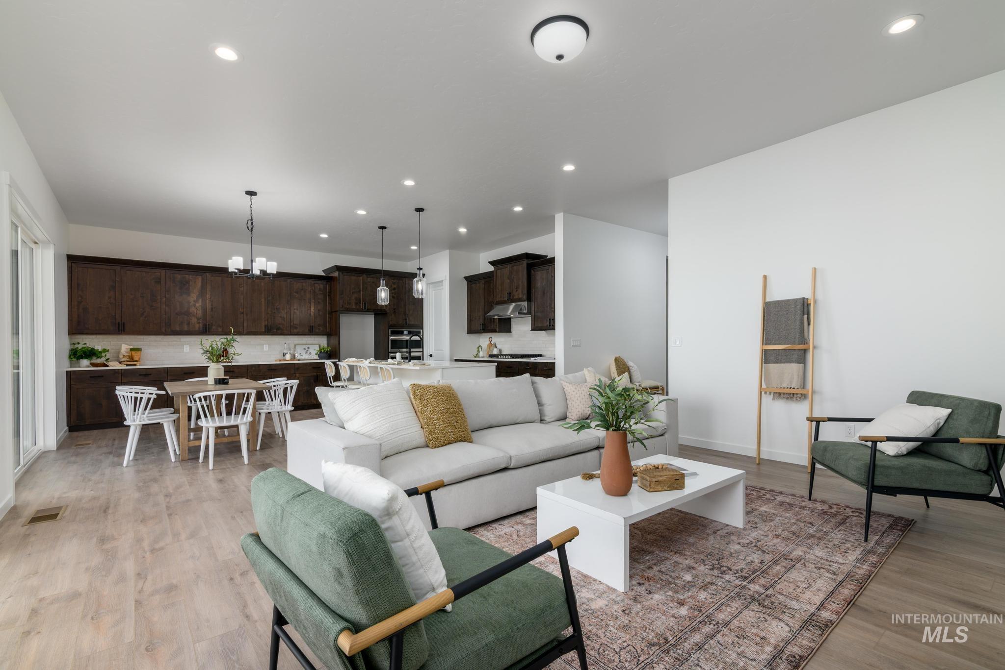 15086 Steel Cloud Avenue Caldwell, ID 83607 - Photo 9 of 41 Living room with a chandelier, light wood finished floors, and recessed lighting