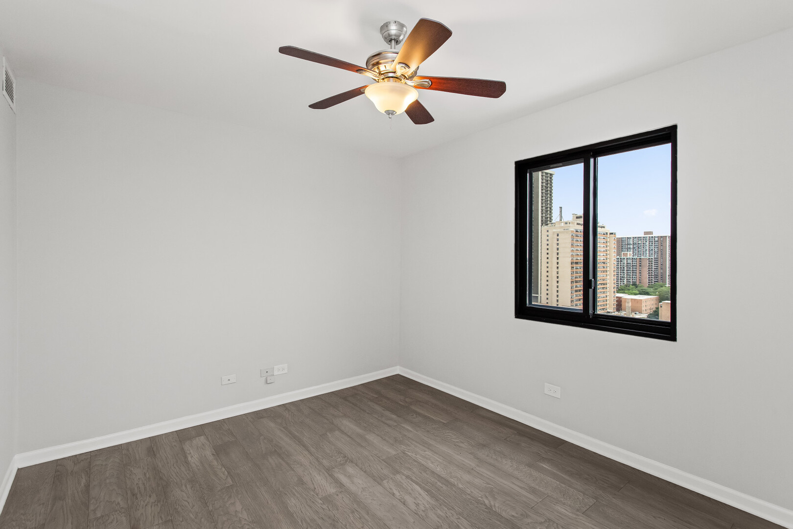 6150 North Kenmore Avenue, Unit 15B Chicago, IL 60660 - Photo 16 of 26 wooden floor in an empty room with a window