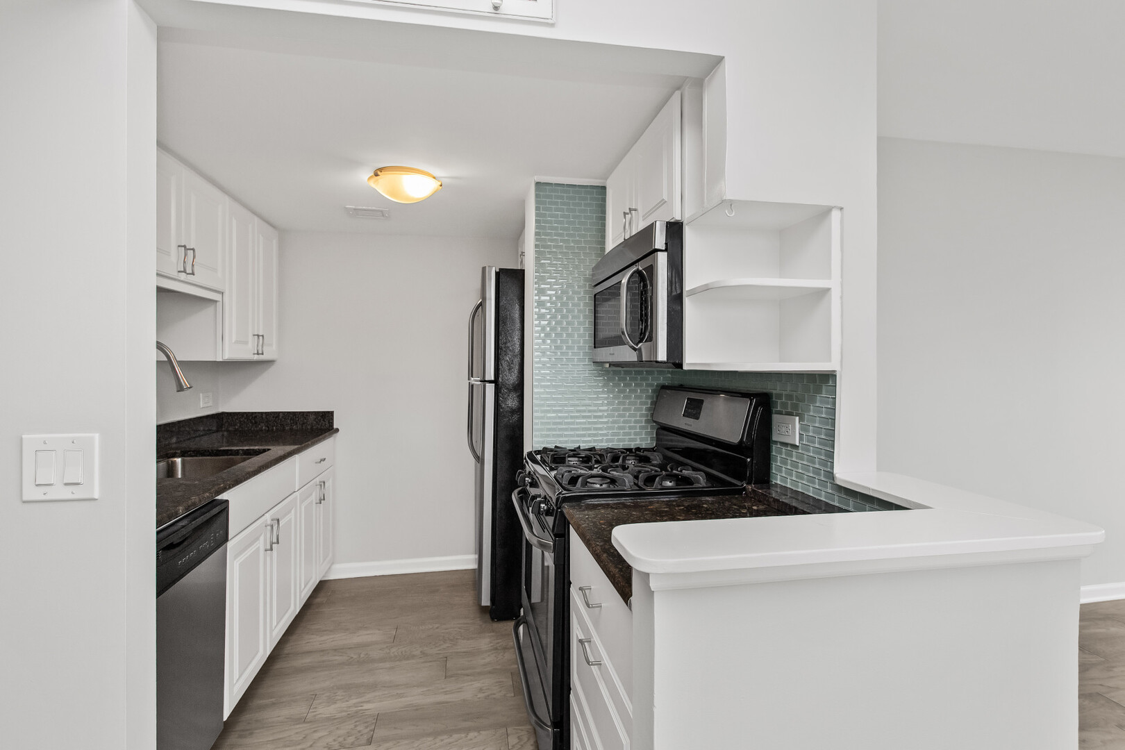 6150 North Kenmore Avenue, Unit 15B Chicago, IL 60660 - Photo 9 of 26 a kitchen with stainless steel appliances a stove a sink and a refrigerator