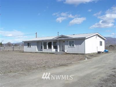 100 Weatherstone Road Omak, WA 98841 - Photo 1 of 1 a front view of a house with a yard