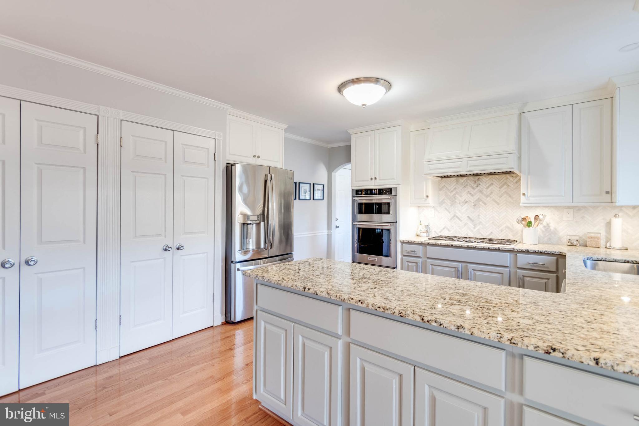 1007 St Stephens Road Alexandria, VA 22304 - Photo 19 of 59 a kitchen with stainless steel appliances granite countertop a refrigerator sink and cabinets