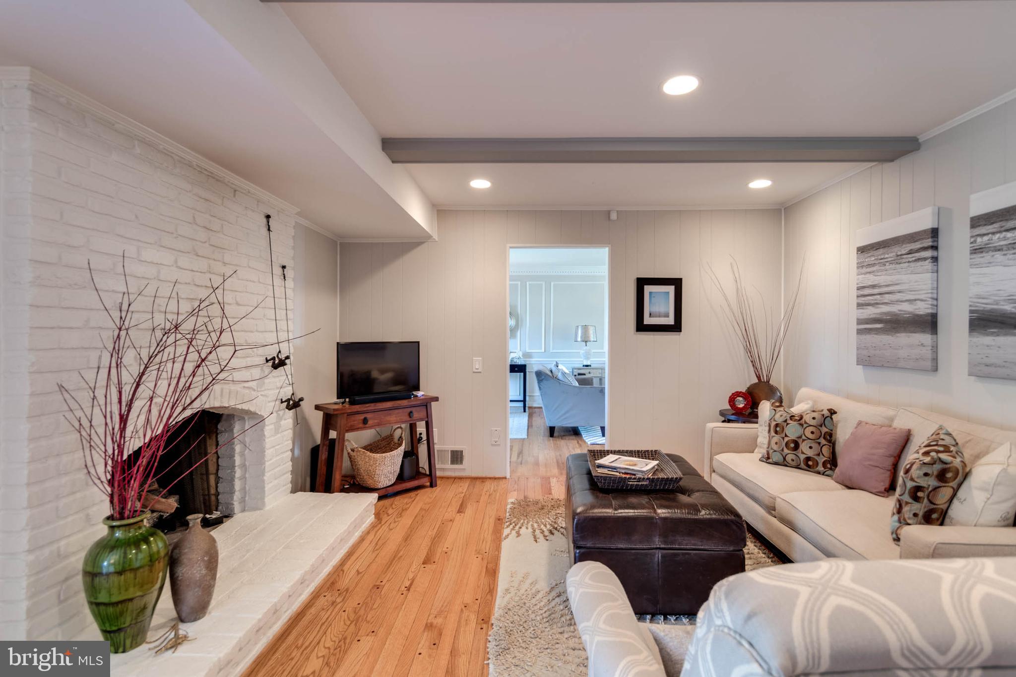 1007 St Stephens Road Alexandria, VA 22304 - Photo 24 of 59 a living room with furniture flat screen tv and a fireplace