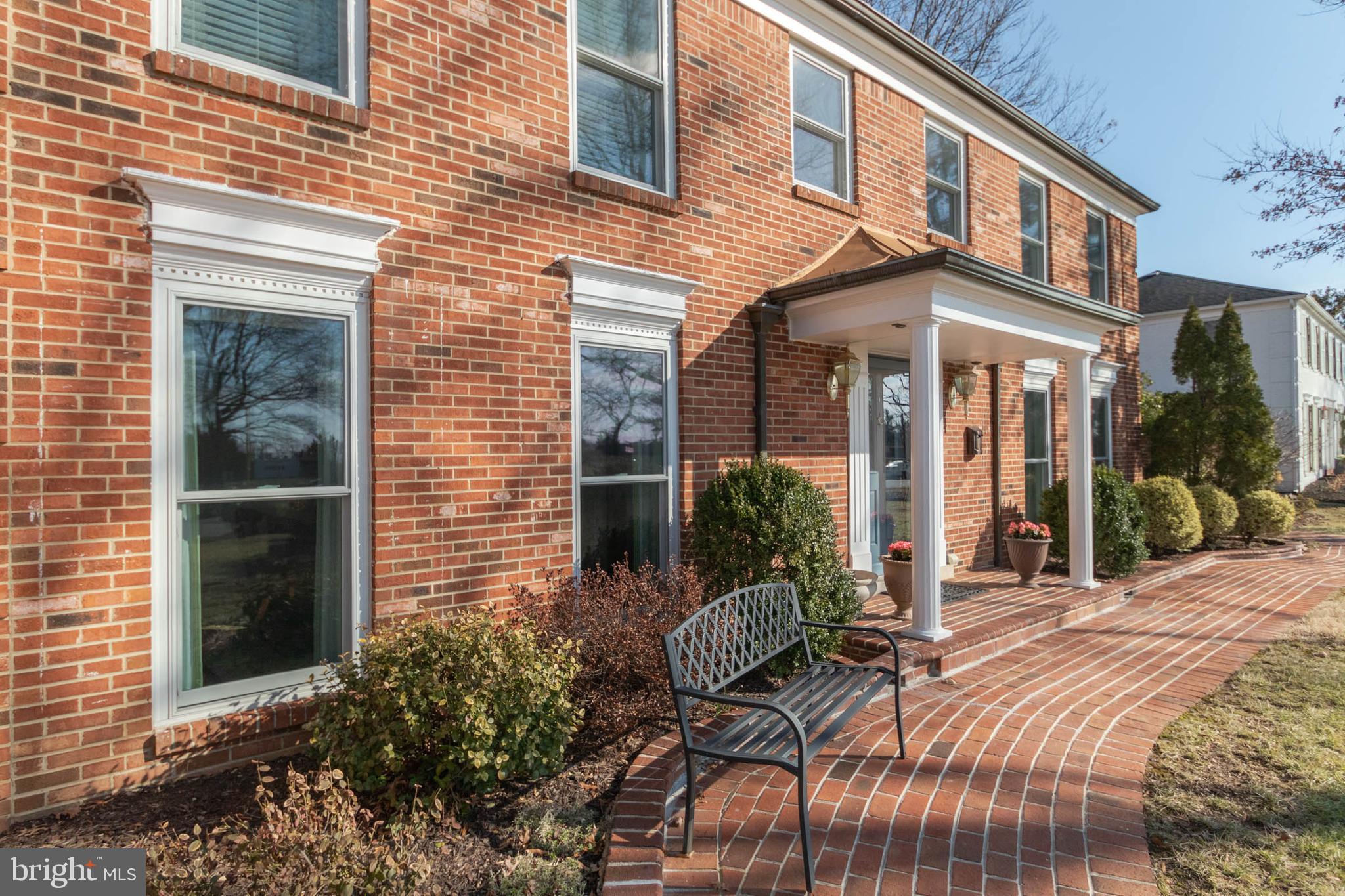 1007 St Stephens Road Alexandria, VA 22304 - Photo 3 of 59 a view of a brick house with lawn chairs and floor to ceiling window