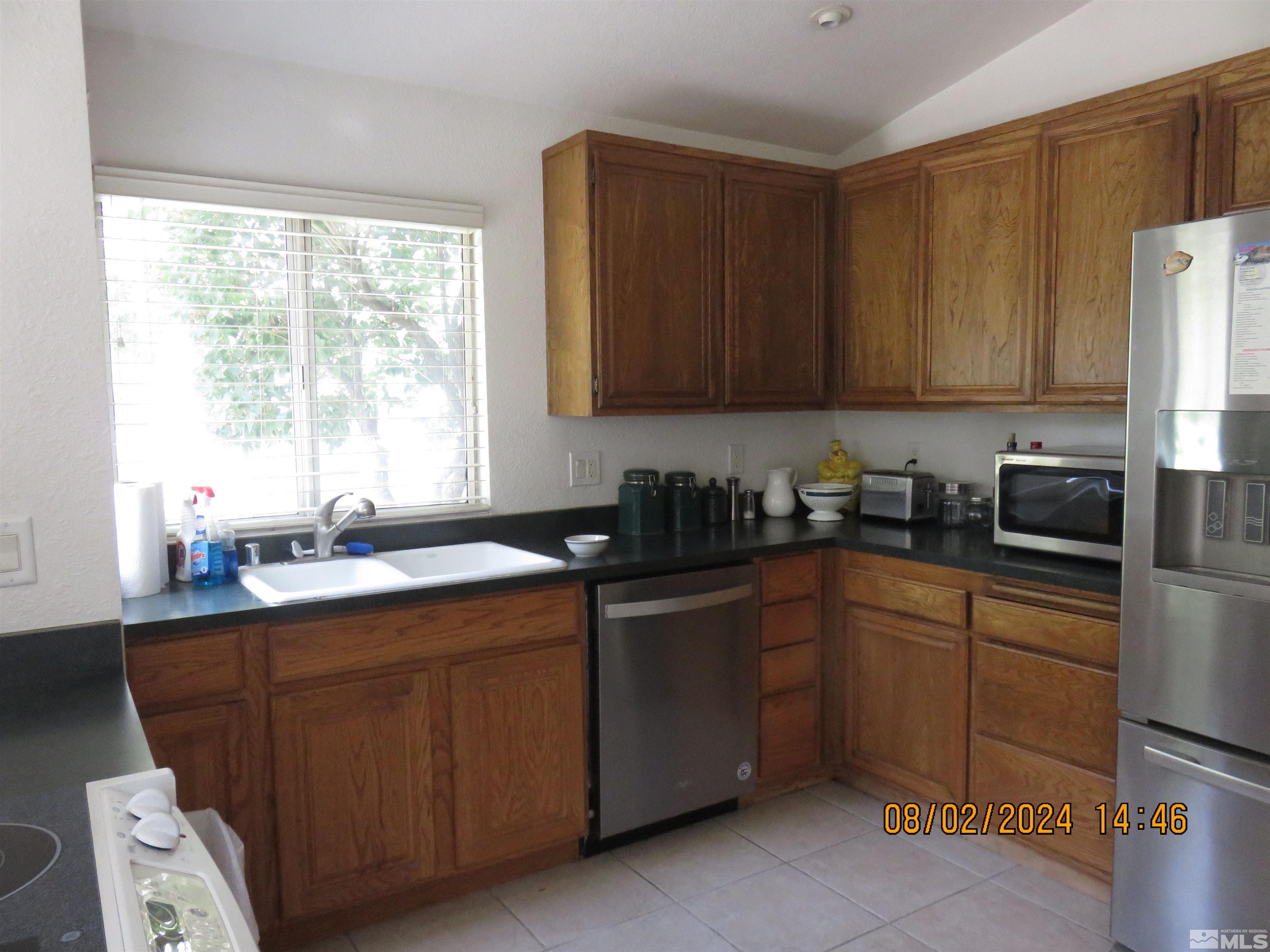 7131 Lighthouse Lane Reno, NV 89511 - Photo 3 of 11 a kitchen with a sink cabinets and window