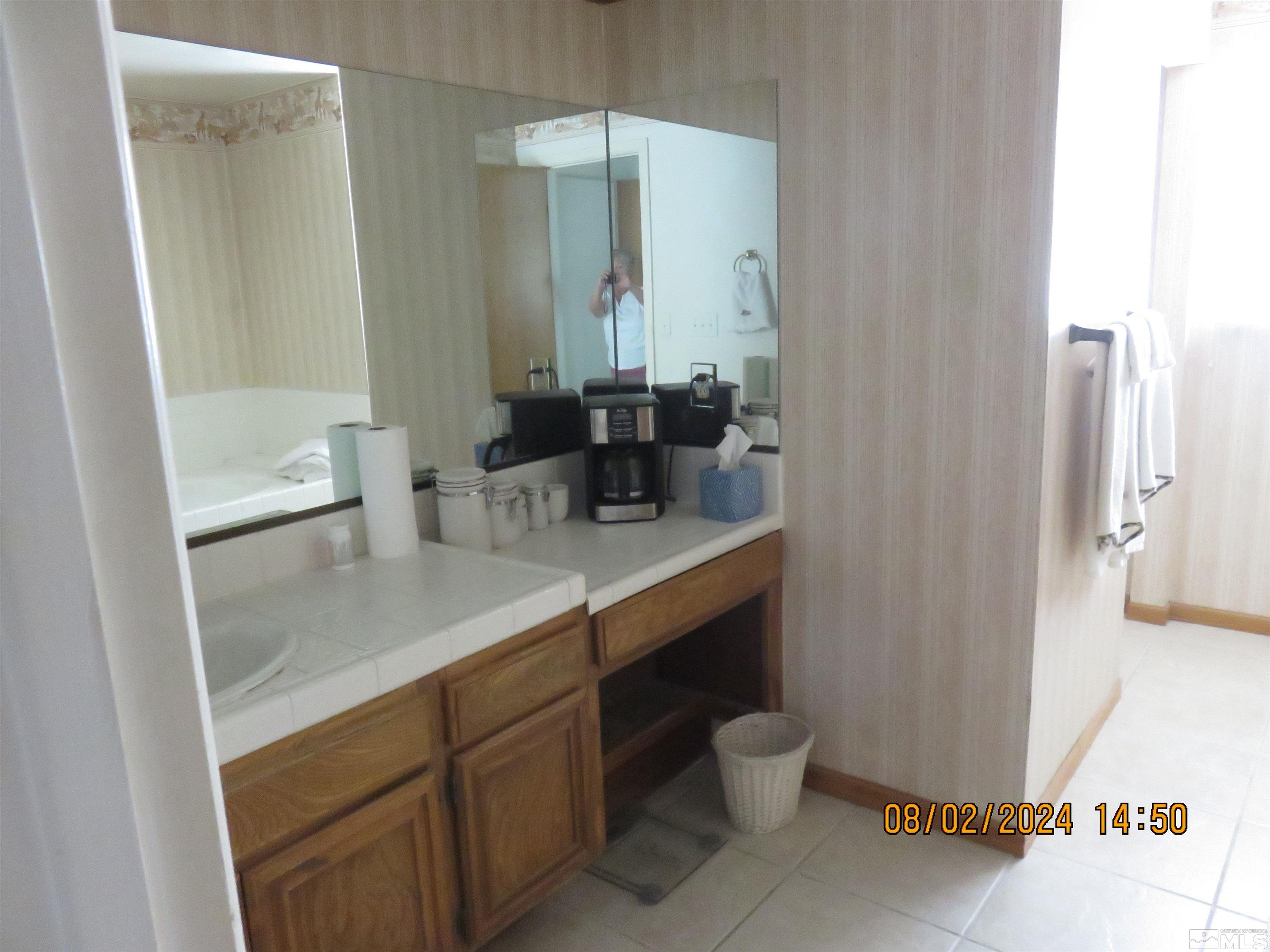 7131 Lighthouse Lane Reno, NV 89511 - Photo 9 of 11 a bathroom with a sink a toilet and shower