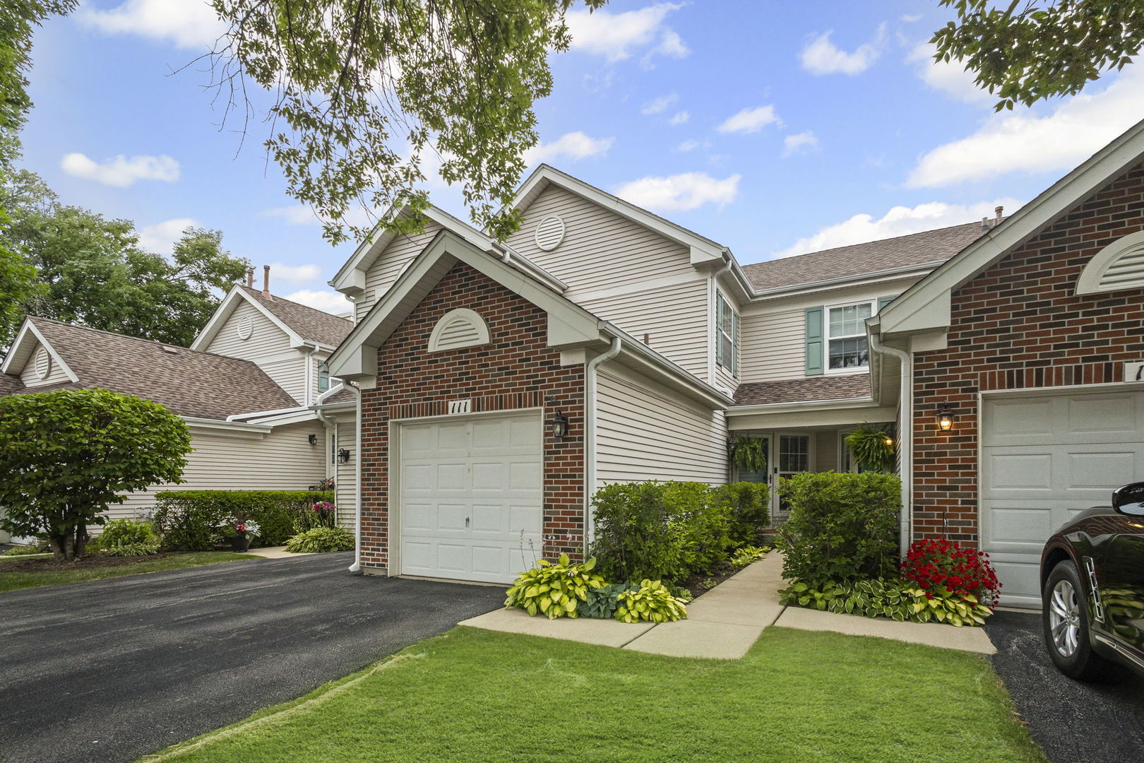 111 Cathy Lane Mount Prospect, IL 60056 - Photo 2 of 36 a front view of a house with a garden and plants