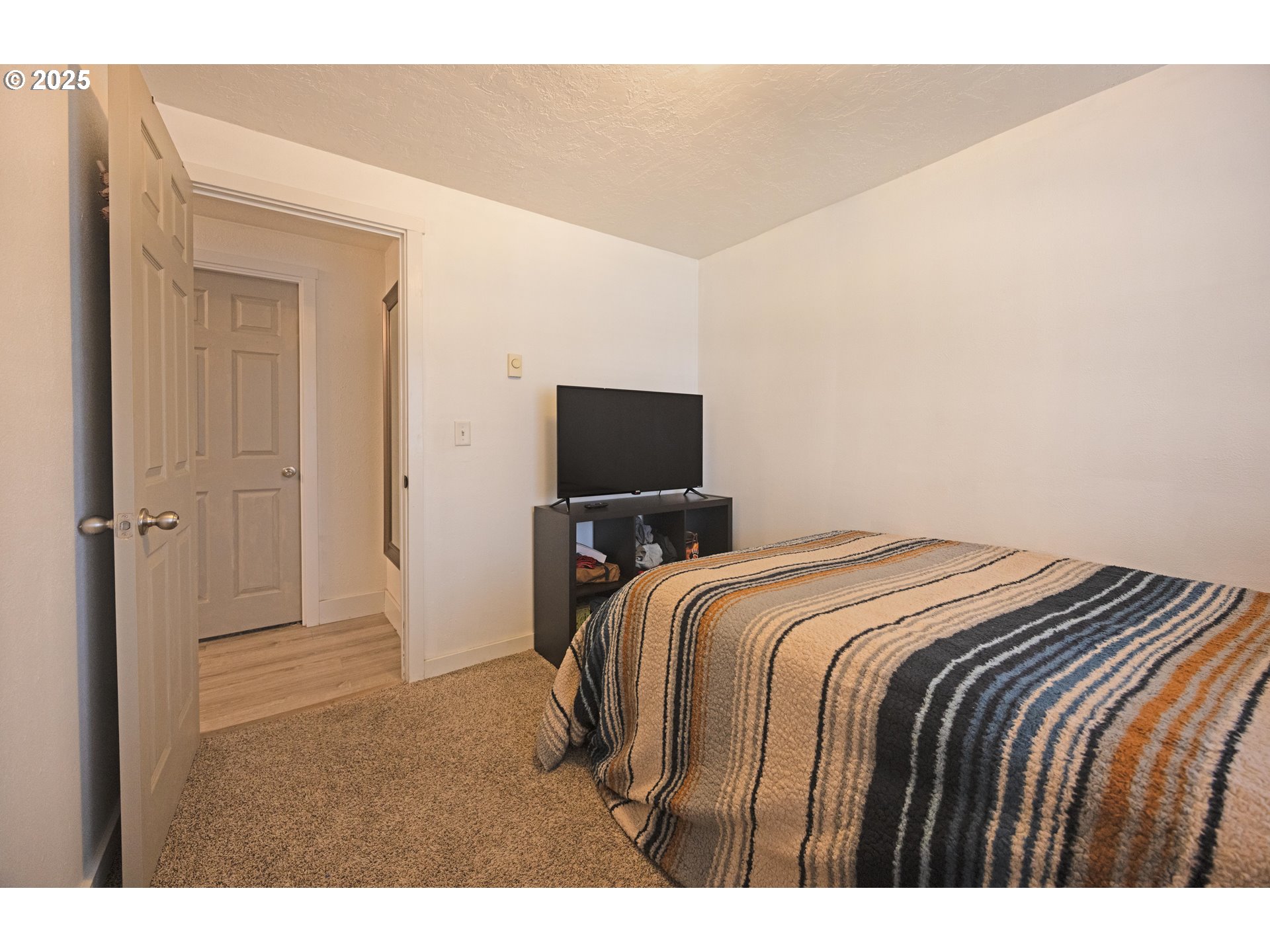 824 56th Street Springfield, OR 97478 - Photo 15 of 31 a bedroom with a bed and a flat screen tv