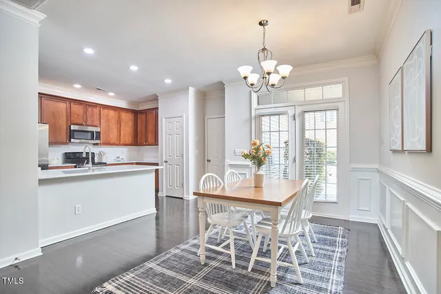 a kitchen with stainless steel appliances a sink stove refrigerator and cabinets