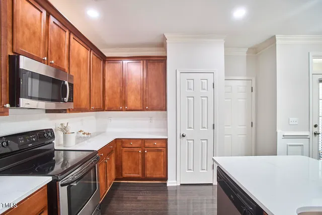 a kitchen with stainless steel appliances a stove a microwave and sink