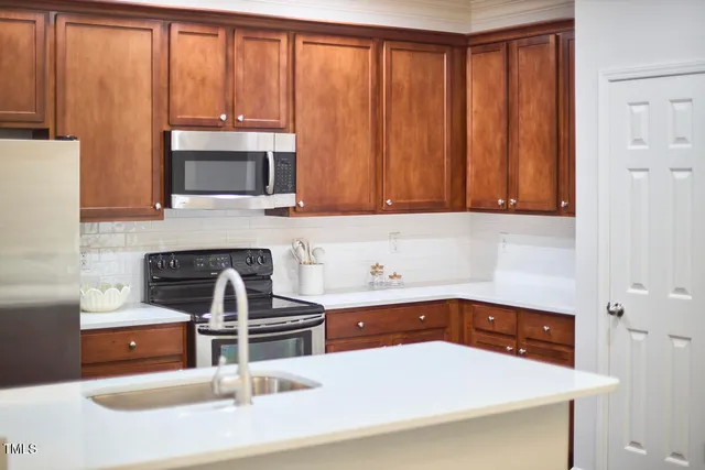 a kitchen that has a table and chairs in it