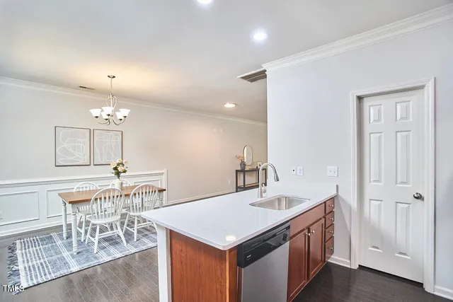 a kitchen with stainless steel appliances a sink a stove a microwave and cabinets