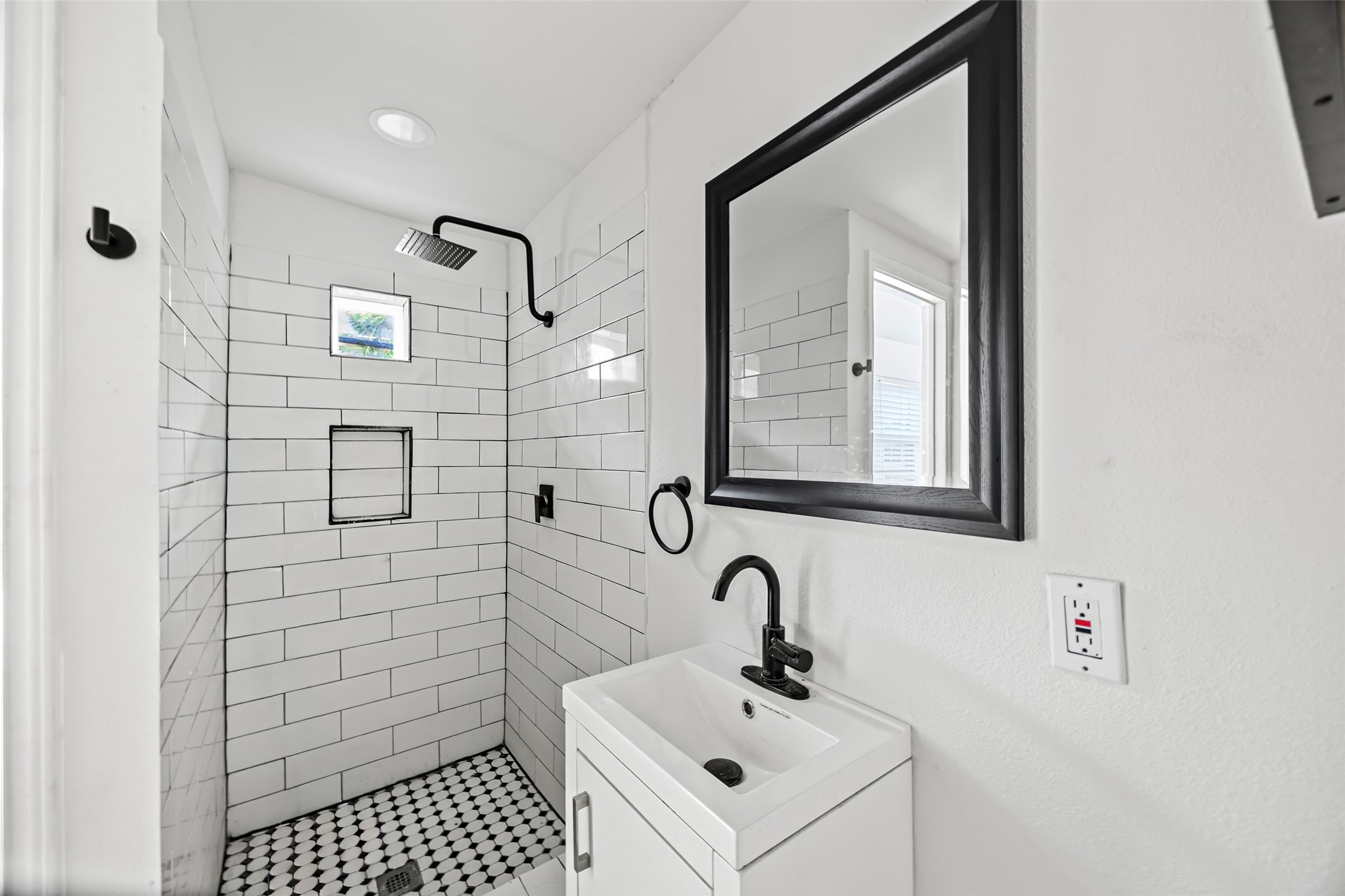 7303 Market Street Houston, TX 77020 - Photo 13 of 18 a bathroom with a sink and mirror