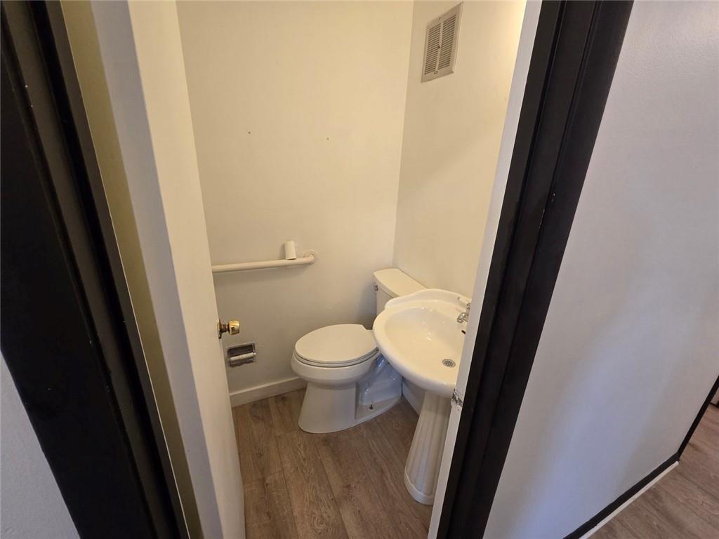 1297 Tree Creek Court Clarkston, GA 30021 - Photo 12 of 31 a white toilet sitting next to a sink