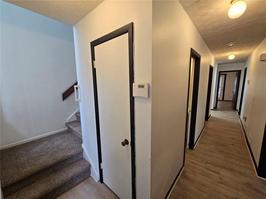 1297 Tree Creek Court Clarkston, GA 30021 - Photo 13 of 31 a view of a hallway with wooden floor and staircase