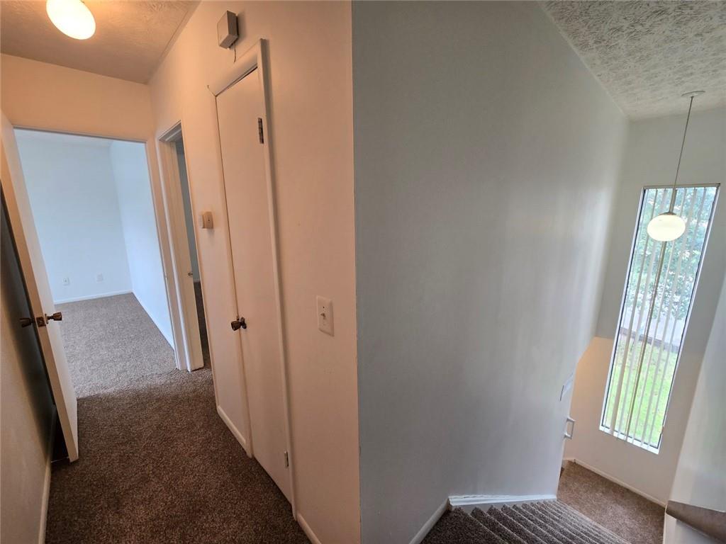 1297 Tree Creek Court Clarkston, GA 30021 - Photo 15 of 31 a view of a hallway with windows and stairs