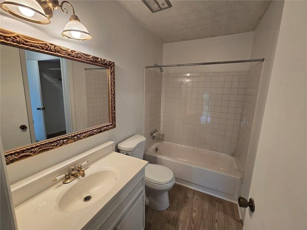 1297 Tree Creek Court Clarkston, GA 30021 - Photo 16 of 31 a bathroom with a sink a toilet and shower