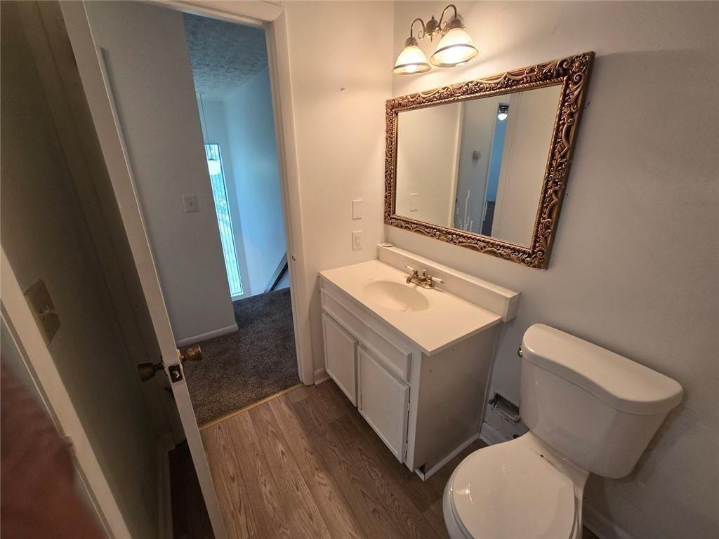 1297 Tree Creek Court Clarkston, GA 30021 - Photo 17 of 31 a bathroom with a sink mirror vanity and toilet