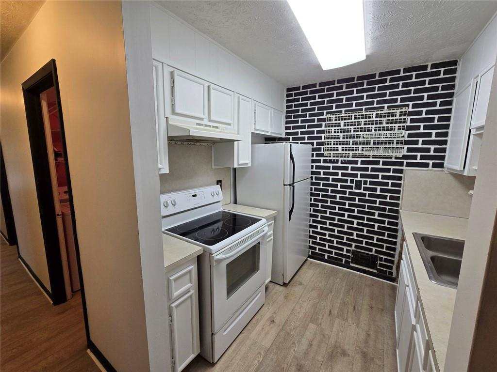1297 Tree Creek Court Clarkston, GA 30021 - Photo 2 of 31 a kitchen with a stove and a refrigerator
