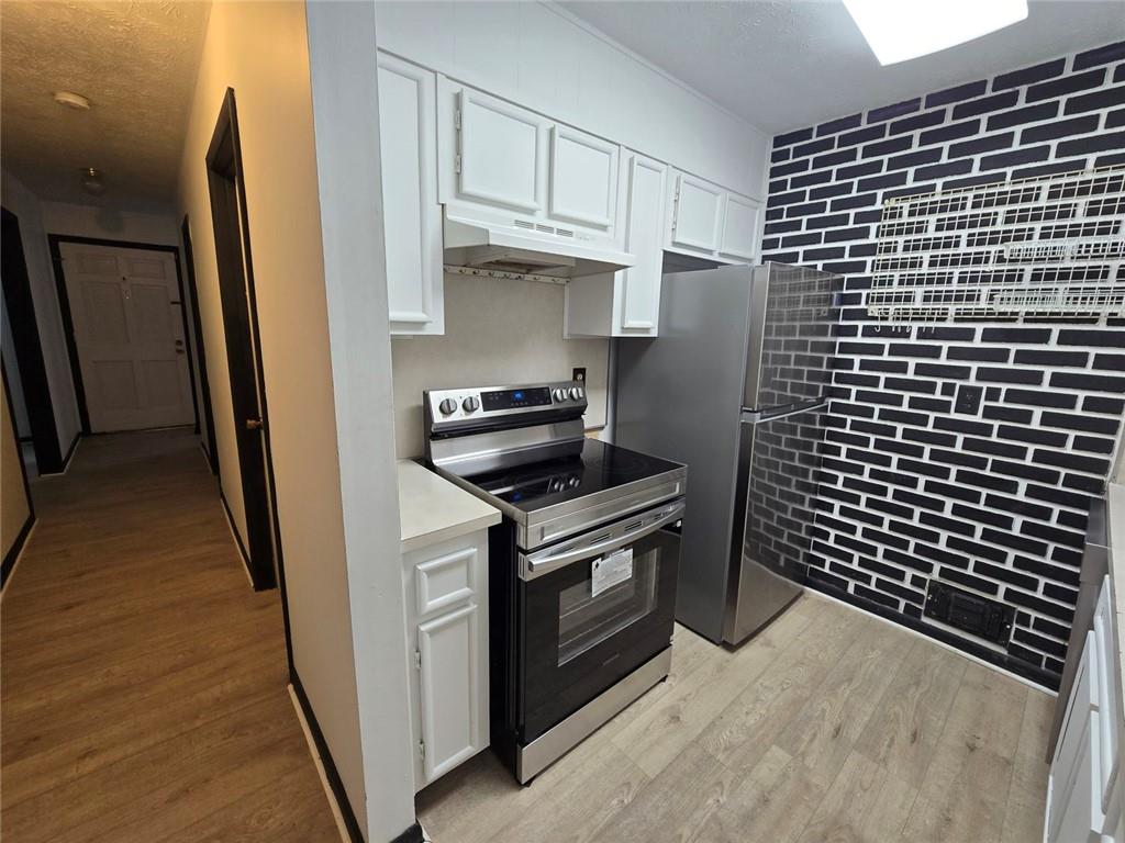 1297 Tree Creek Court Clarkston, GA 30021 - Photo 2 of 31 a kitchen with cabinets and a stove