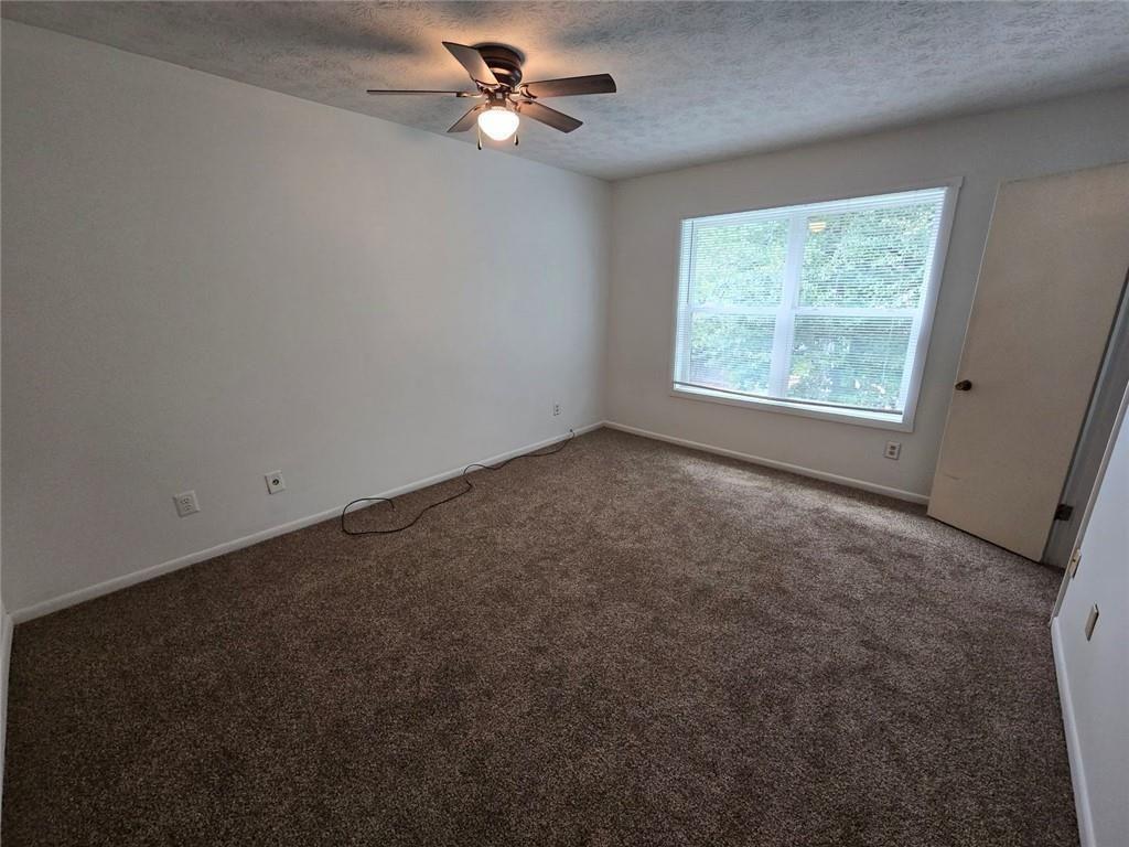 1297 Tree Creek Court Clarkston, GA 30021 - Photo 23 of 31 wooden floor in an empty room with a window