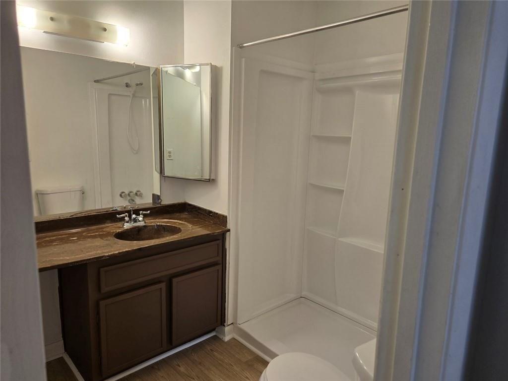 1297 Tree Creek Court Clarkston, GA 30021 - Photo 26 of 31 a bathroom with a granite countertop sink a mirror and shower