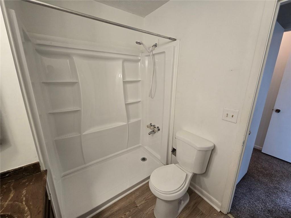 1297 Tree Creek Court Clarkston, GA 30021 - Photo 27 of 31 a bathroom with a toilet and a shower