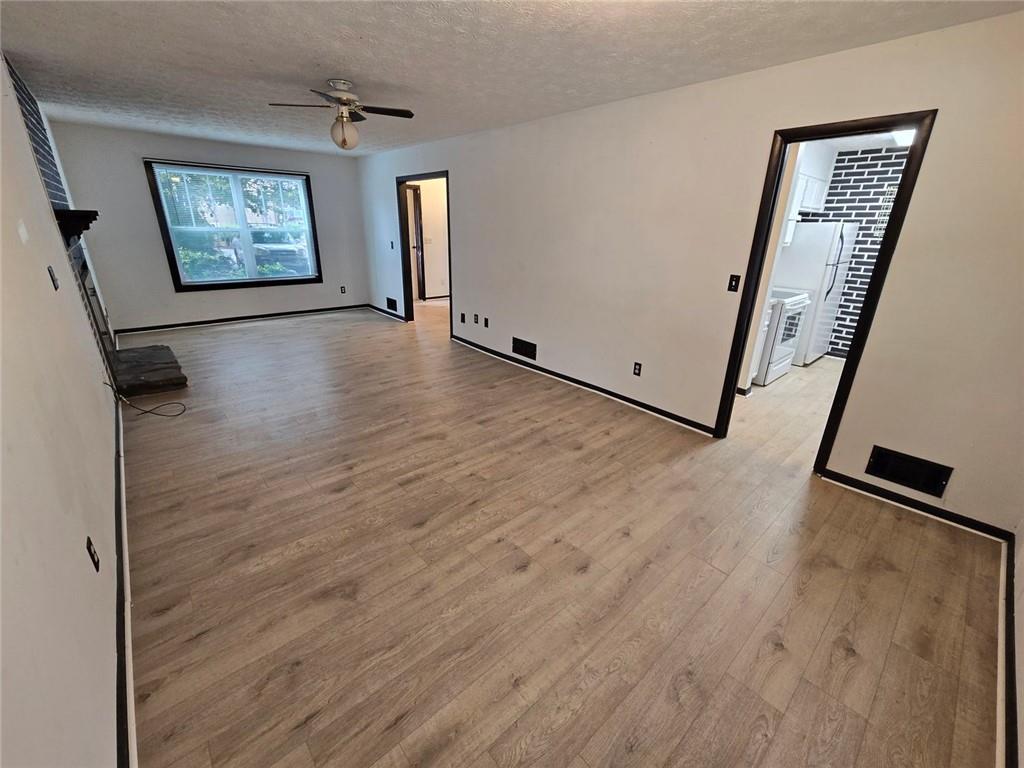 1297 Tree Creek Court Clarkston, GA 30021 - Photo 8 of 31 a view of a hallway with wooden floor and stairs