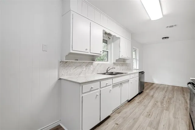 a kitchen with granite countertop white cabinets and white appliances