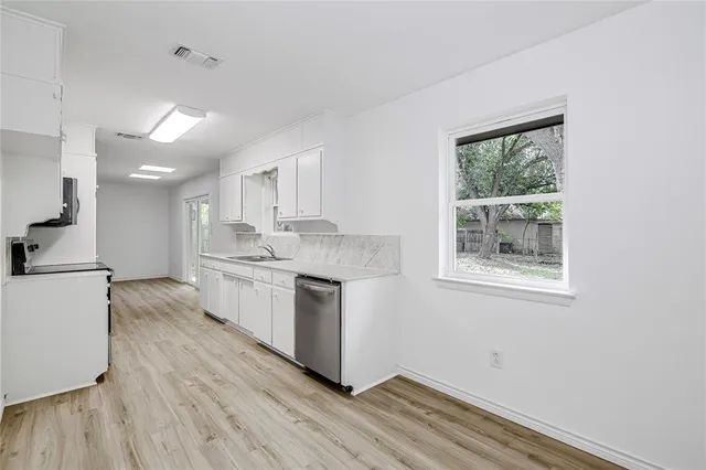 a kitchen with a refrigerator and a stove top oven