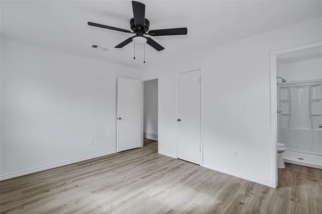 a view of an empty room and wooden floor
