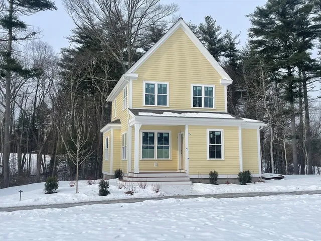 a view of a house with a yard covered in snow