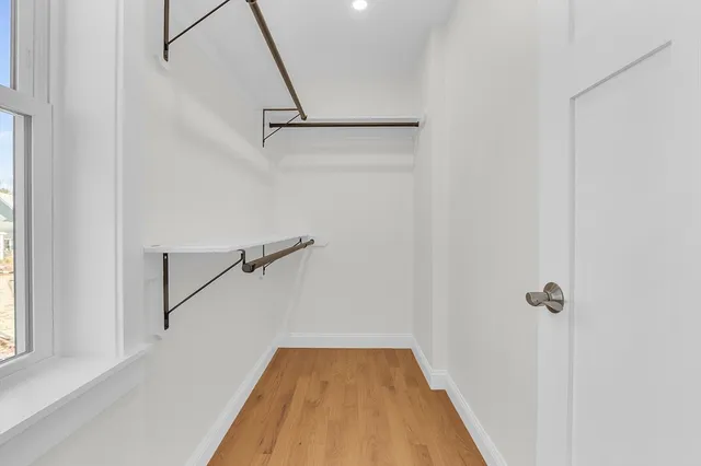 a view of a room with wooden floor and staircase
