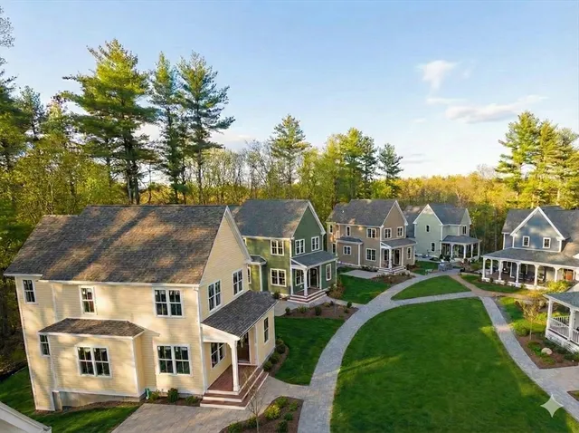 a front view of residential houses with yard and green space