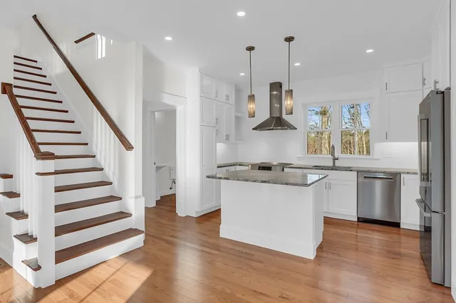 a kitchen with stainless steel appliances kitchen island a refrigerator sink and stove