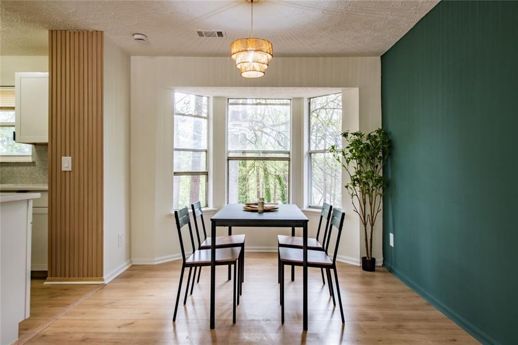 3493 Newberry Trail Decatur, GA 30034 - Photo 14 of 48 a dining room with furniture a chandelier and wooden floor