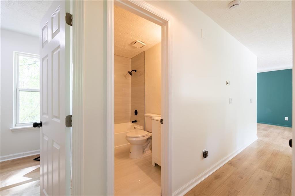 3493 Newberry Trail Decatur, GA 30034 - Photo 23 of 48 a bathroom with a granite countertop shower a toilet and a sink
