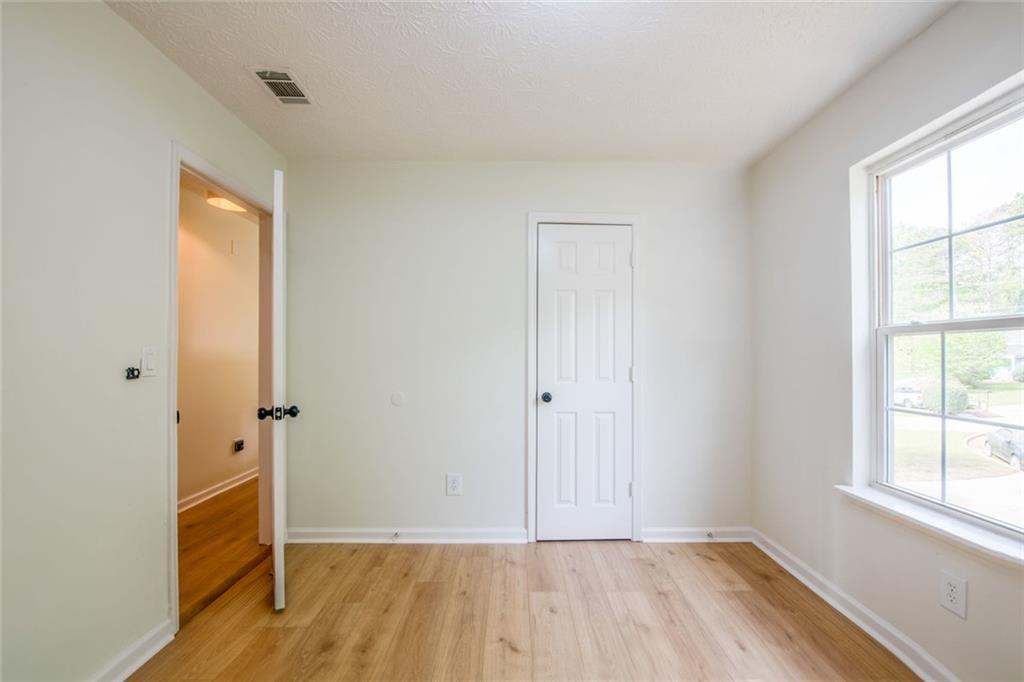 3493 Newberry Trail Decatur, GA 30034 - Photo 26 of 48 an empty room with wooden floor and a window