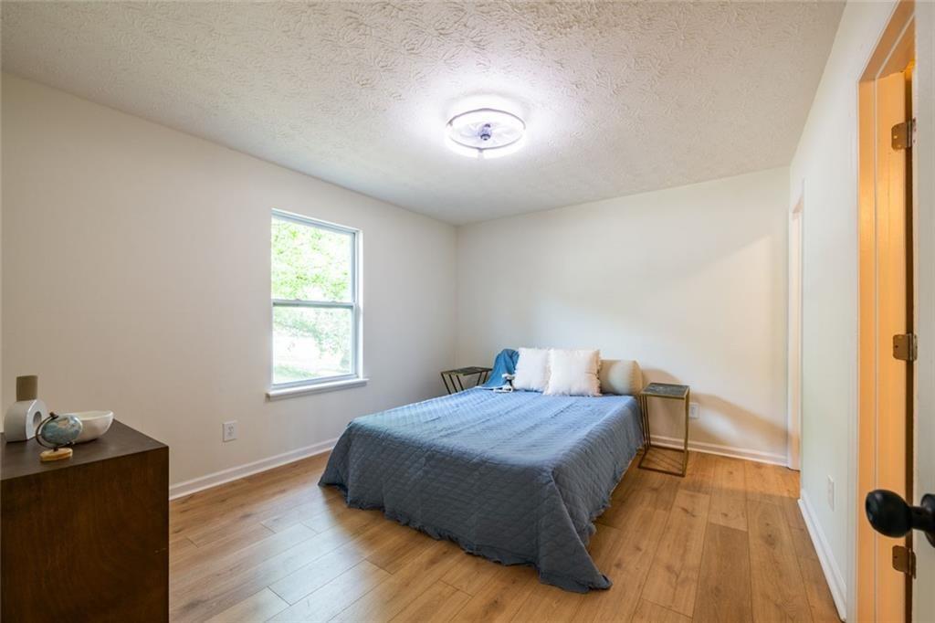 3493 Newberry Trail Decatur, GA 30034 - Photo 35 of 48 a bedroom with a bed and wooden floor