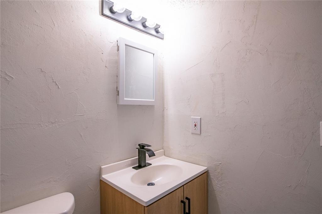 3493 Newberry Trail Decatur, GA 30034 - Photo 39 of 48 a bathroom with a sink a toilet and mirror